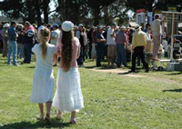 image of girls in their best dresses drifting through the crowd in pairs